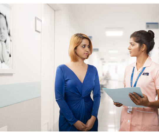 A patient who travelled to Chennai for fertility treatment, with a Jananam nurse in the corridor at the Neelankarai hospital
