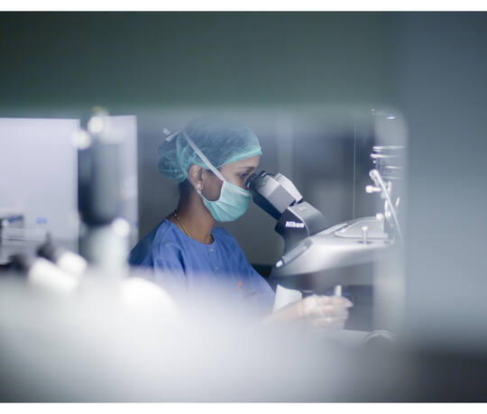 An embryologist at a microscope in the clean-room embryology lab at Jananam Fertility Centre, Neelankarai, Chennai