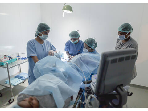 The Jananam team, gowned and capped, around the table in the egg collection theatre at Jananam Fertility Centre, Neelankarai, Chennai