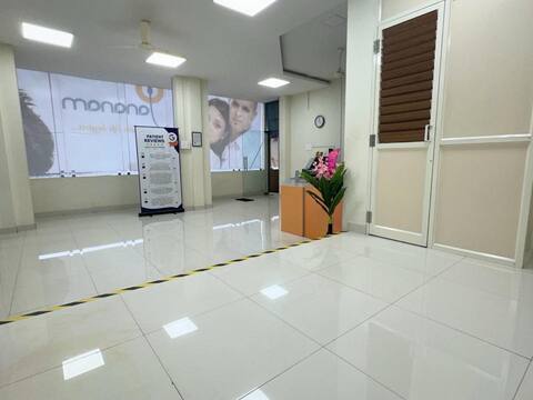 The entrance lobby at Jananam Fertility Centre, Thiruporur, with the clinic's window graphic and a stand of patient reviews